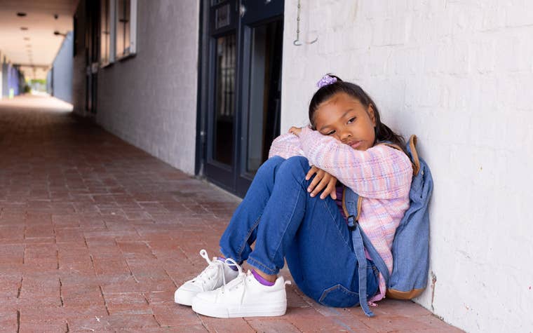 Young girl sad in a hallway