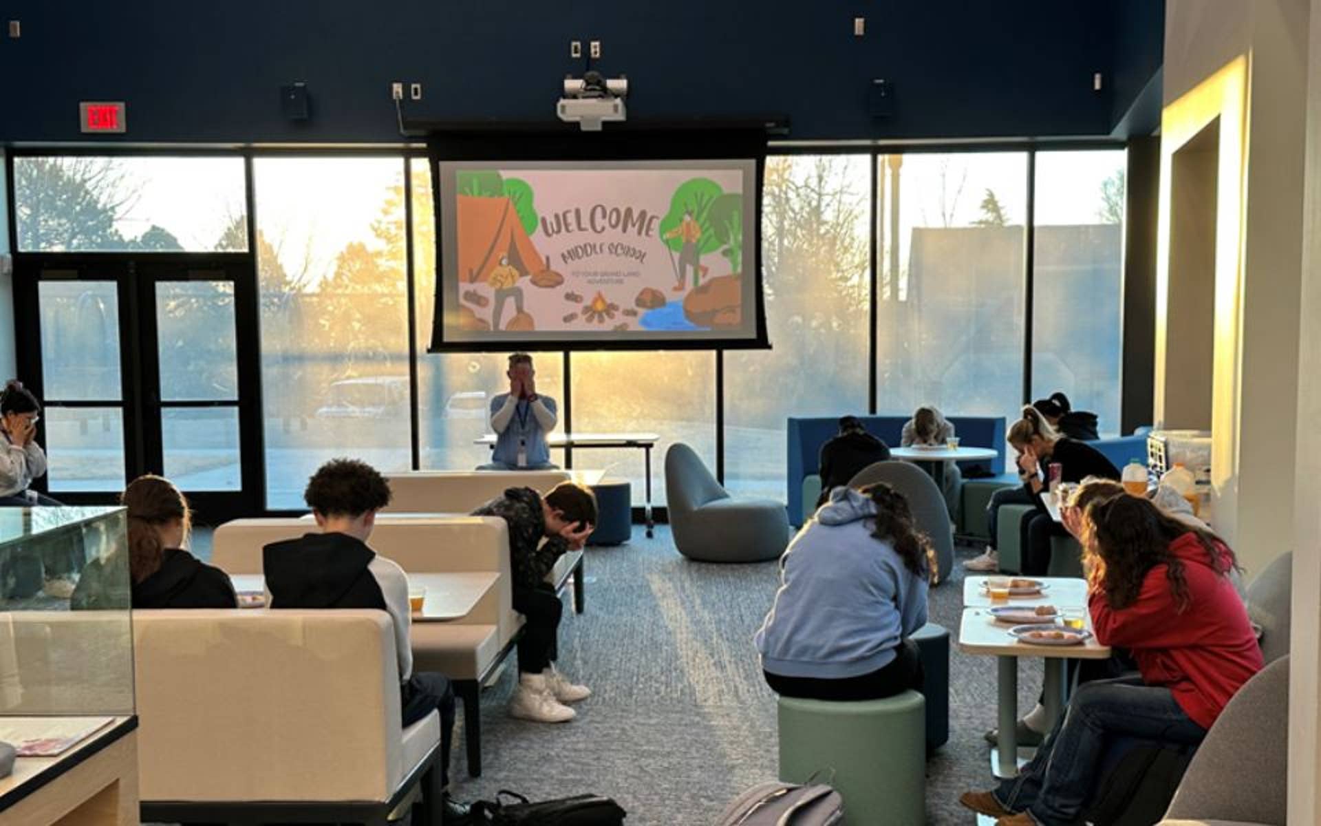 boys and girls in a classroom with a projector 