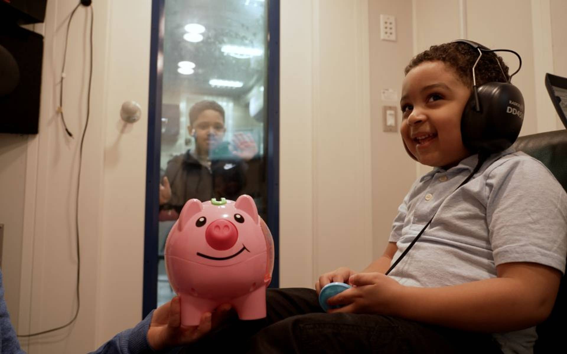 Young boy having hearing tested in Research Vehicle