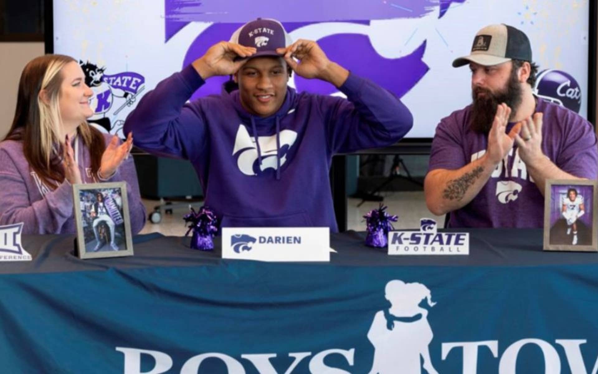 Darien putting on his K-State hat