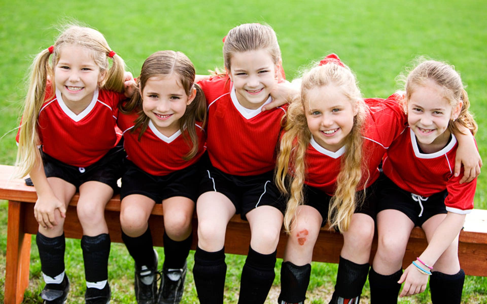 Young soccer players sitting on a bench