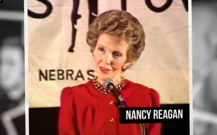 Nancy Reagan wearing a red dress talking into a microphone 
