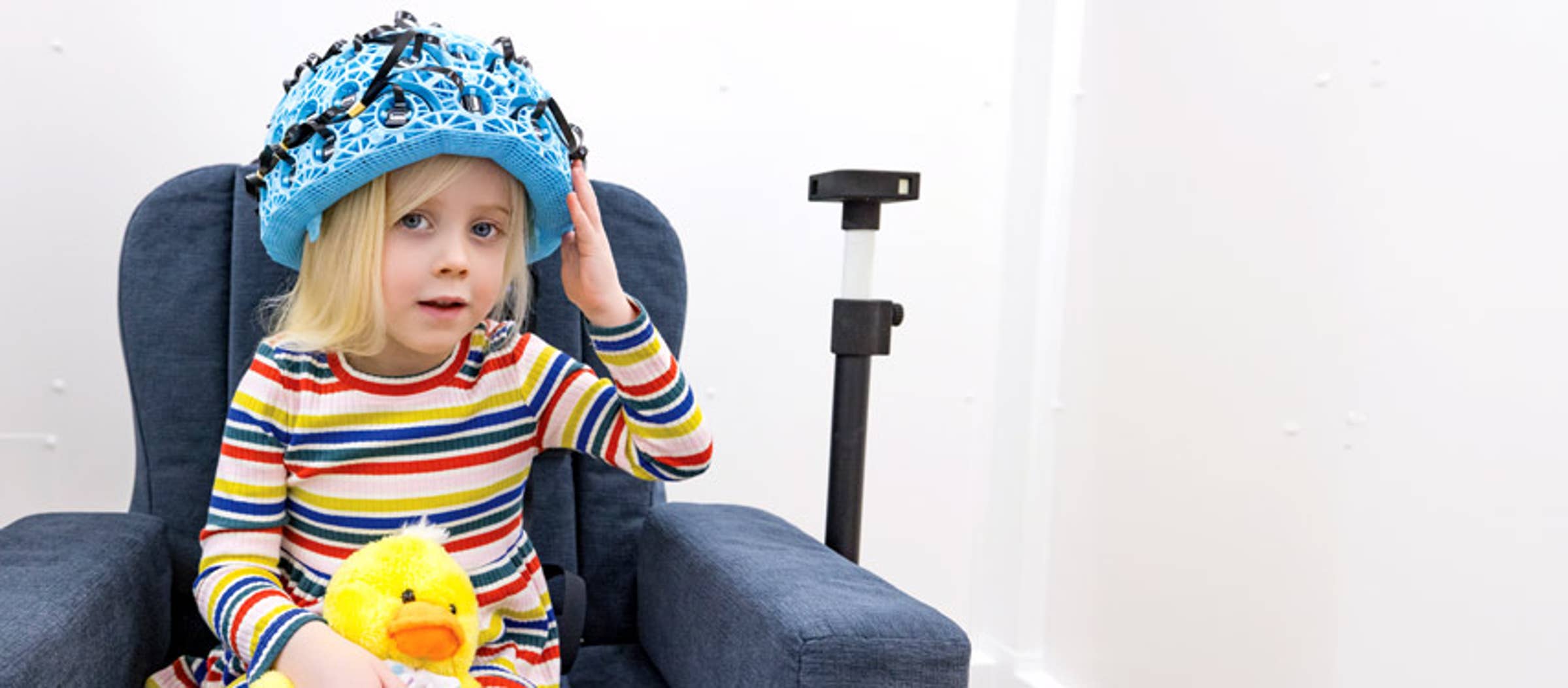 Young child wearing advanced diagnostic helmet