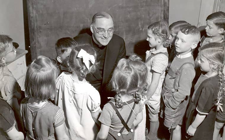 Father Flanagan teaching kids in a classroom